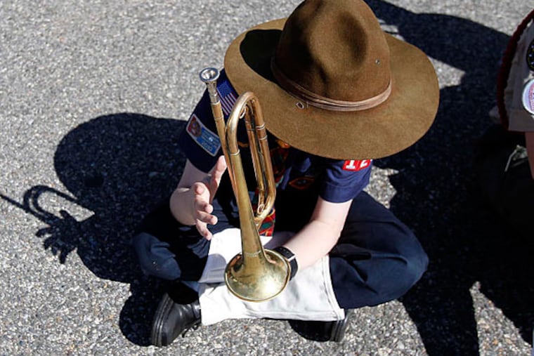 Cub Scout Luke Borkowski (above), of Troop 226, waits with fellow Scouts yesterday before the Bridesburg Memorial Day parade. (David Maialetti/Staff)