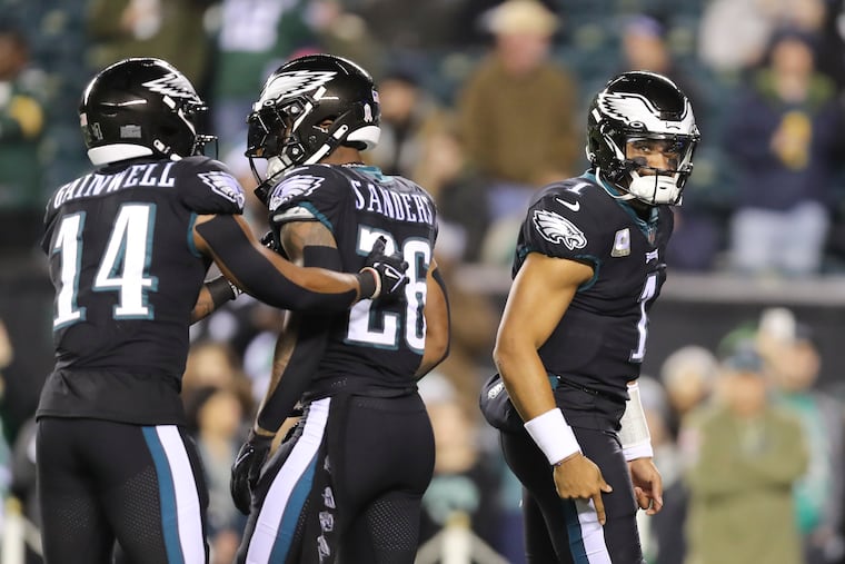 Eagles quarterback Jalen Hurts with teammates Eagles running back's Miles Sanders and Kenneth Gainwell during warm ups before the Eagles take on the Green Bay Packers on Sunday, November 27, 2022 in Philadelphia.