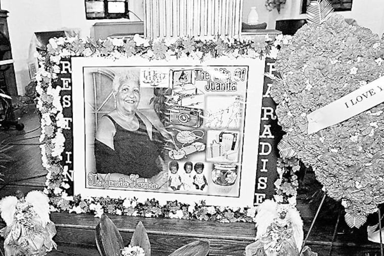Juanita Harmon in a photo displayed with flowers in front of the altar during her funeral service Thursday at City of Refuge Church in Grays Ferry. She died last week in the collapse of a building on Market Street. (ALEJANDRO A. ALVAREZ / Staff Photographer)