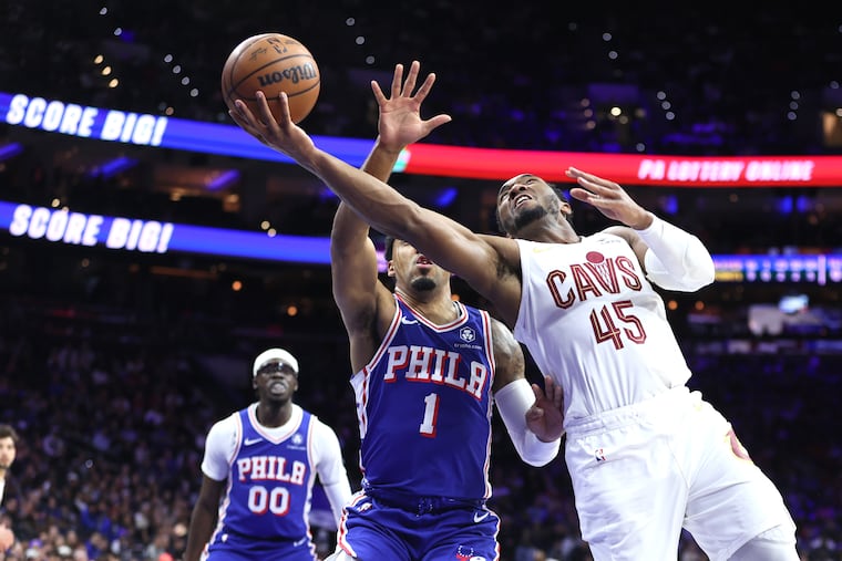 Cavaliers guard Donovan Mitchell (right) scores past Sixers' KJ Martin during Wednesday's matchup.