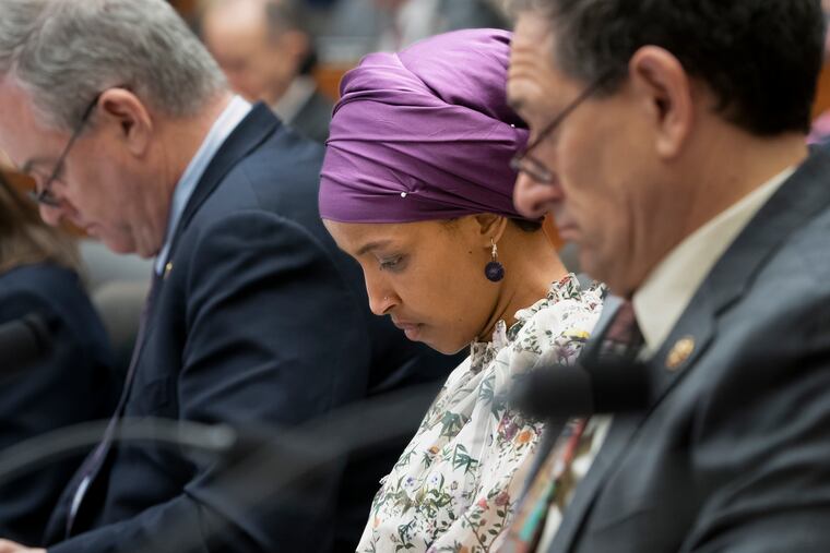 Rep. Ilhan Omar, D-Minn., sits with fellow Democrats, Rep. David Trone, D-Md., left, and Rep. Mike Levin, D-Calif., right, on the House Education and Labor Committee during a bill markup, on Capitol Hill in Washington, Wednesday, March 6, 2019.