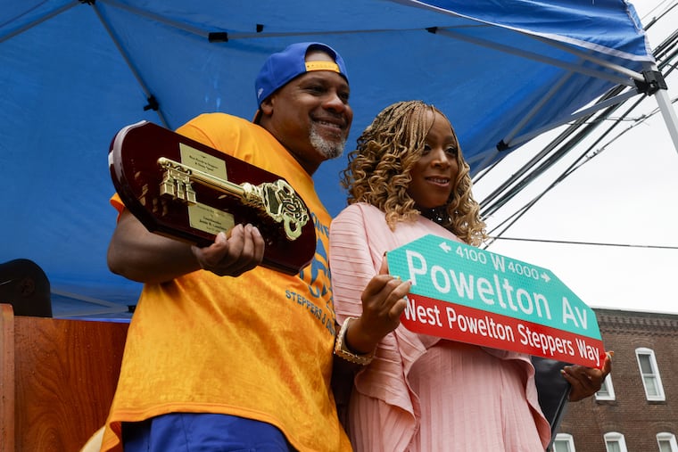 Antoine Mapp, the director of the West Powelton Steppers and Drumline, receives the key to the city by council member Jamie R. Gauthier on Saturday. The event honored the organization with a street renaming ceremony.
