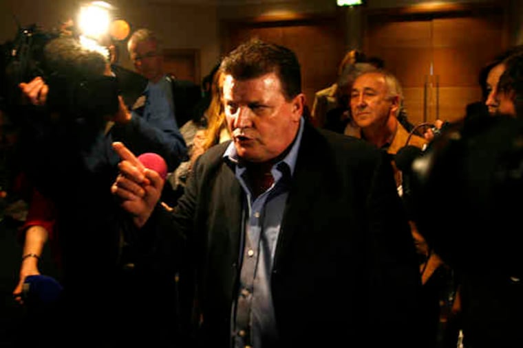 John Kelly, a former industrial-school student who now leads Irish Survivors of Child Abuse, shouts at commission members after being denied access to yesterday's news conference.