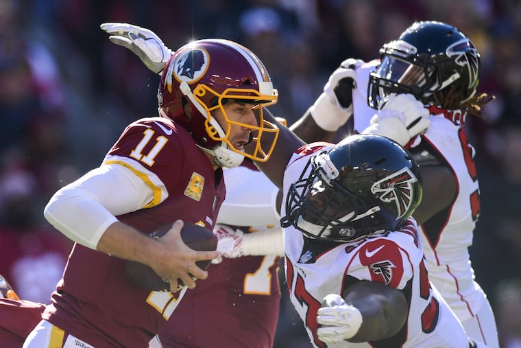 Atlanta Falcons defensive tackle Grady Jarrett, right, sacks Washington Redskins quarterback Alex Smith (11) during the first half of an NFL football game, Sunday, Nov. 4, 2018 in Landover, Md. (AP Photo/Susan Walsh)