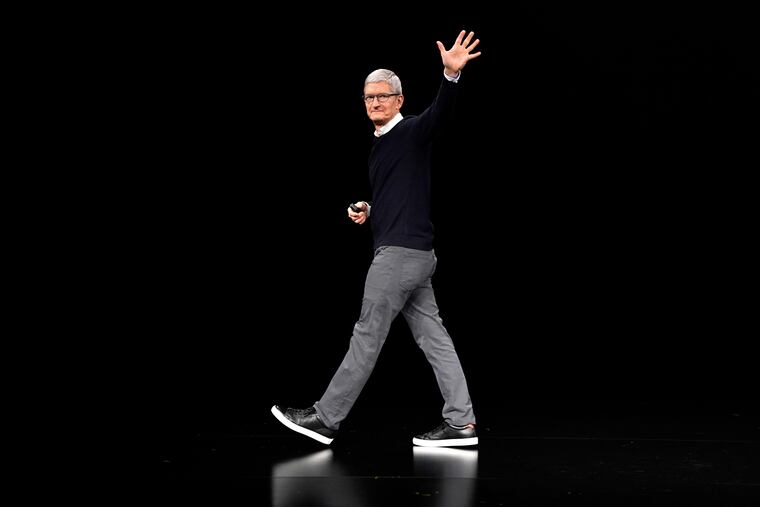FILE - Apple CEO Tim Cook waves while walking off stage at the Steve Jobs Theater after an event to announce new products Monday, March 25, 2019, in Cupertino, Calif.