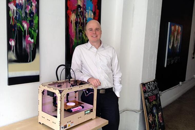Chris Cera, founder of Arcweb, stands next to MakerBot 3-D printer. Arcweb worked on the software that ships with the printer. (Michael Hinkelman / Daily News Staff)