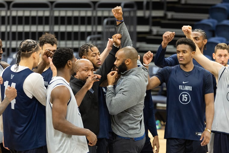 Kyle Neptune (center) enters his third season as Villanova's basketball coach.