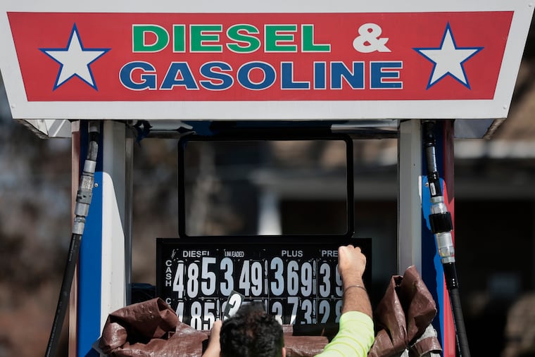 A worker at the Star Gas station in Blackwood, N.J. changes the price of fuel in March.