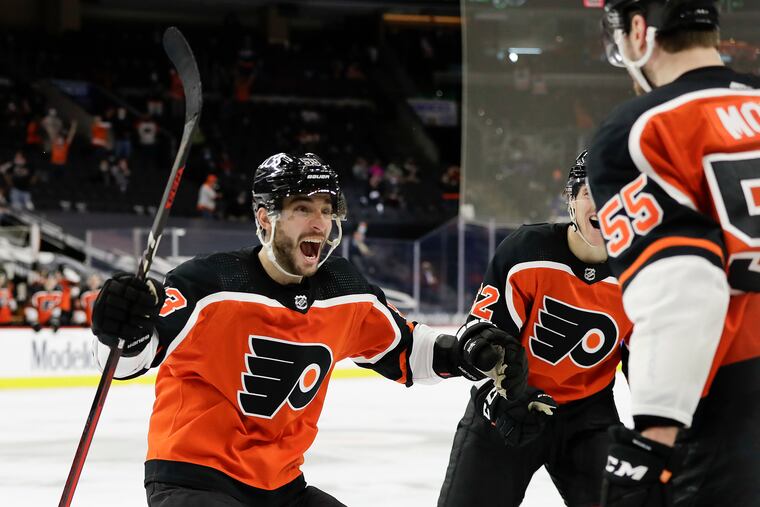 Flyers defenseman Shayne Gostisbehere is about to excitedly maul Samuel Morin after Morin's first career goal on Saturday helped the Flyers beat the Rangers, 2-1.