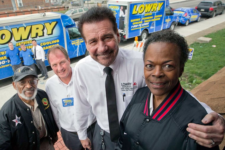 Steve Lowry, (second from right), owner of Lowry Services, is donating a $15,000 heating and cooling system to Leonard Johnson (left) and wife Minnie Moore-Johnson. Looking on is comfort consultant Dave Schwab.