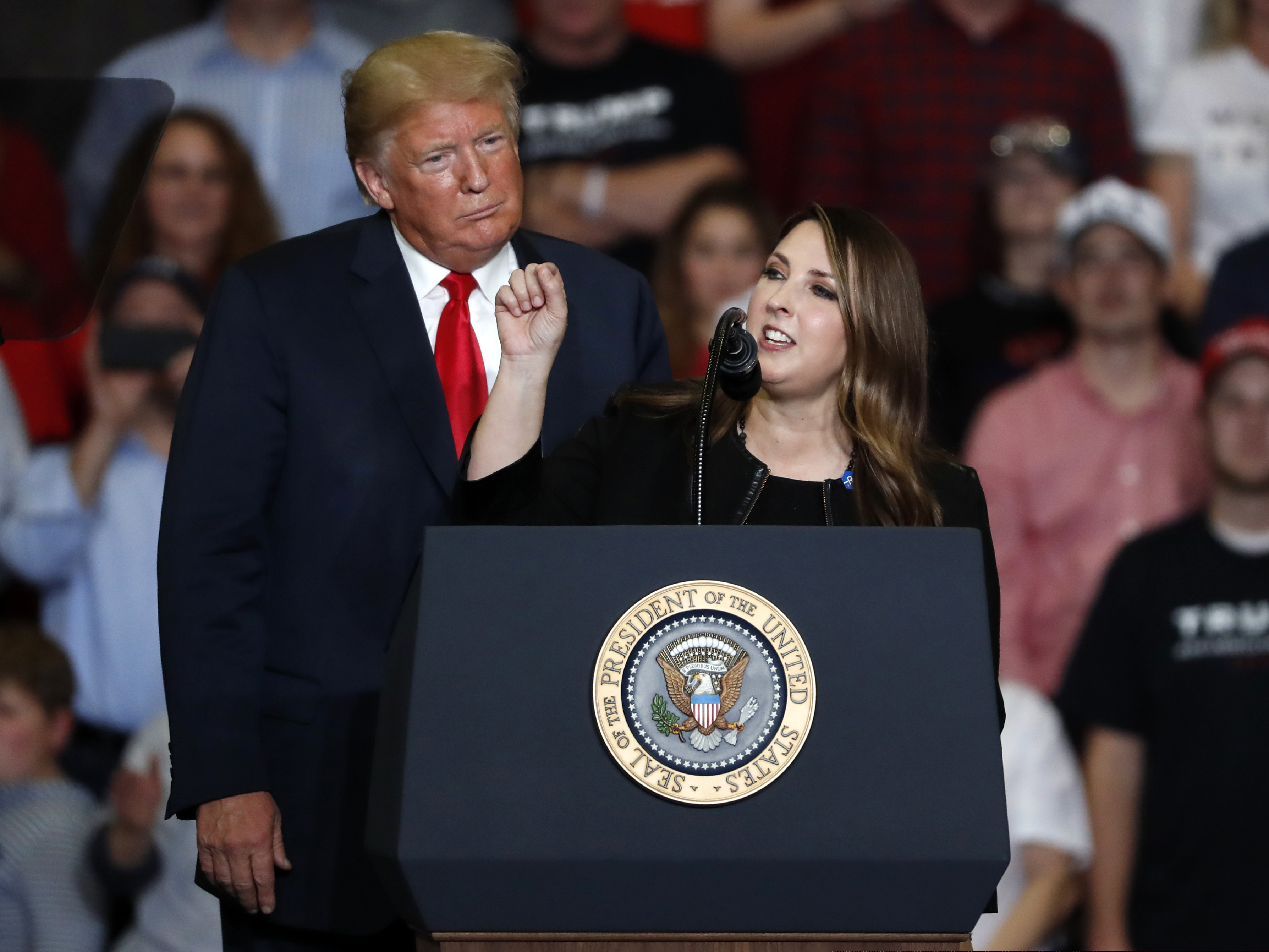 Former President Donald Trump listens as Republican National Committee Chair Ronna McDaniel speaks during a 2018 rally in Cape Girardeau, Mo.