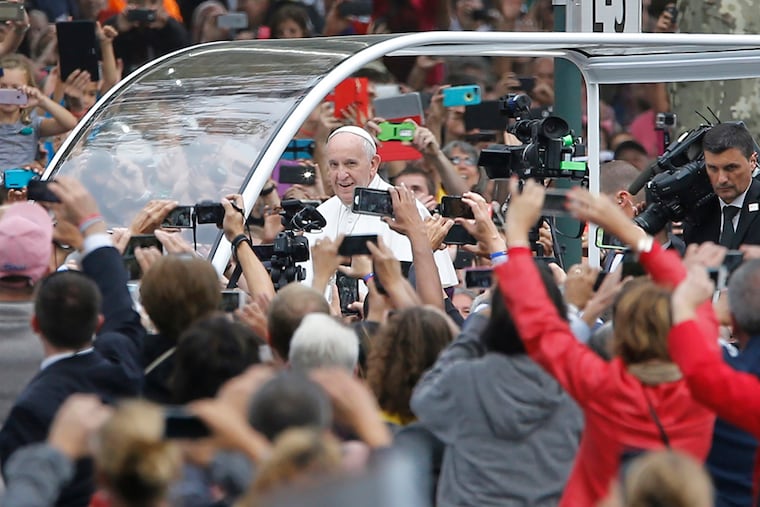 Thousands greet Pope Francis as he travels along the Benjamin Franklin Parkway to celebrate a papal Mass in Philadelphia on Sept. 27, 2015. The city takes another bow on the world stage in 2026, writes Brian Tierney.