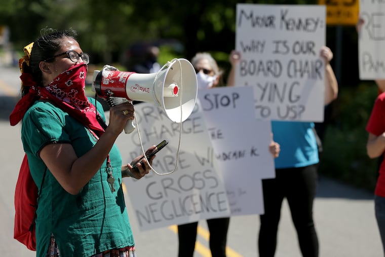 Sunita Baliga, a librarian, gives a speech as workers from the Free Library of Philadelphia protest outside the home of library Board of Trustees President Pamela Dembe's home in August.
