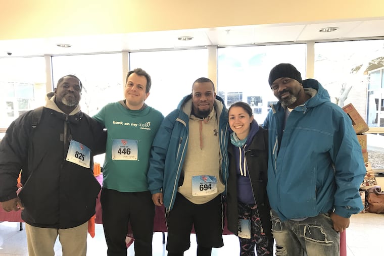 Louis Knight (middle) with members of Back on My Feet.