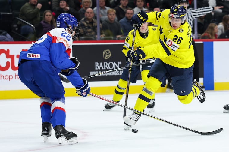 Adam Goljer (left) defends Flyers prospect Jack Berglund during a IIHF World Junior Hockey group stage game in December.