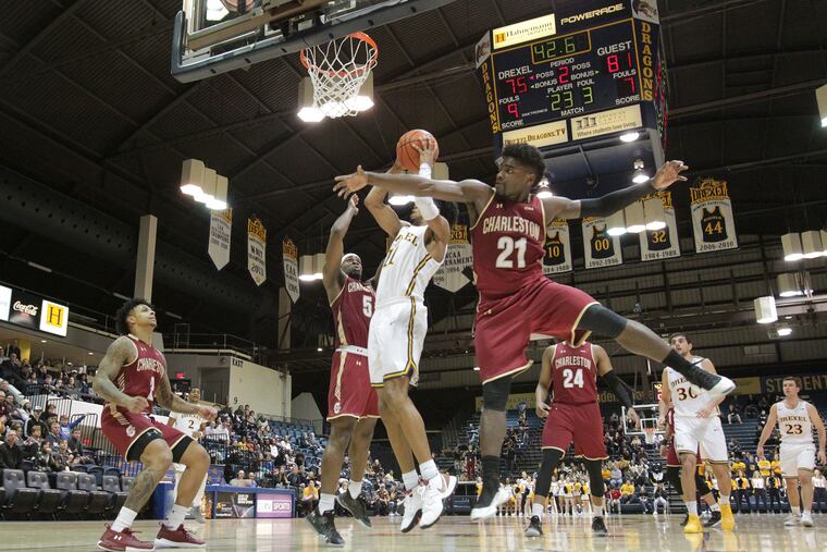 Drexel's Camren Wynter (center) puts up a shot against College of Charleston's Jarrell Brantly (left) and Marquise Pointer during a Feb. 9 game in Philadelphia. The Dragons lost Sunday in the quarterfinals of the CAA tournament.