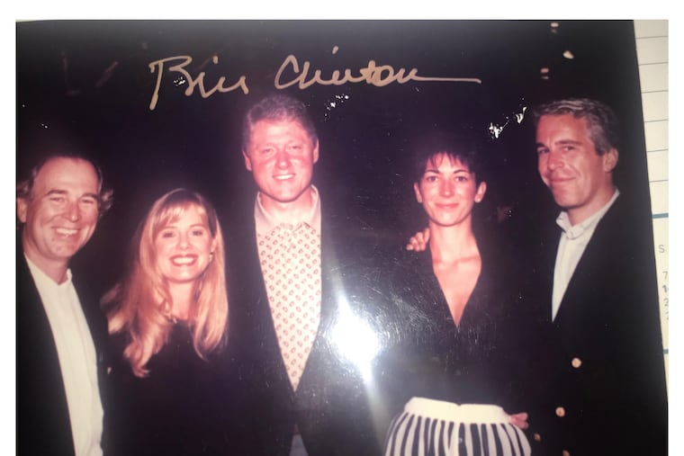 This undated photo released by Democrats on the House Oversight Committee shows former President Bill Clinton, Ghislaine Maxwell, and Jeffrey Epstein, with Clinton's signature at the top of the photo.