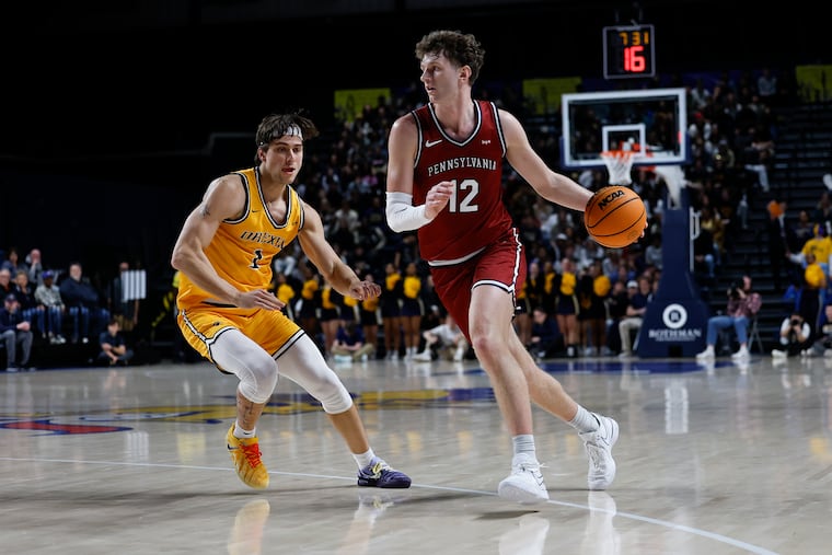 Penn forward TJ Power dribbles the ball against Drexel forward Victor Panov on Friday.