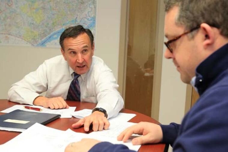 Glenn McAllister, left, Director of the Small Business Development Center at Widener University, meets with Geoff Broome, right, who along with his wife Amy Broome, is considering purchasing a dance studio in Kennett Square. With the economy's collapse and killer federal and state funding cuts, the going has not been easy for Small Business Development Centers. They are a statewide networks of 18 regional offices that provide free help to entrepreneurs. Their existence is dependent on federal and state funding, as well as the colleges and universities that host them. They are lobbying for $1 million in additional state funding. ( CHARLES FOX / Staff Photographer )
