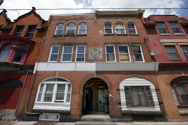 On Hamilton Street in Powelton Village, Kenneth Kramer's brick rental property on the left, and Carlos Colding's familial home on the right. A dispute about a shared chimney started a neighbor war.
