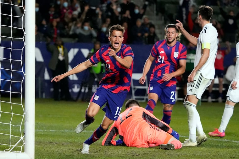 Cole Bassett (center) celebrates after scoring the winning goal.