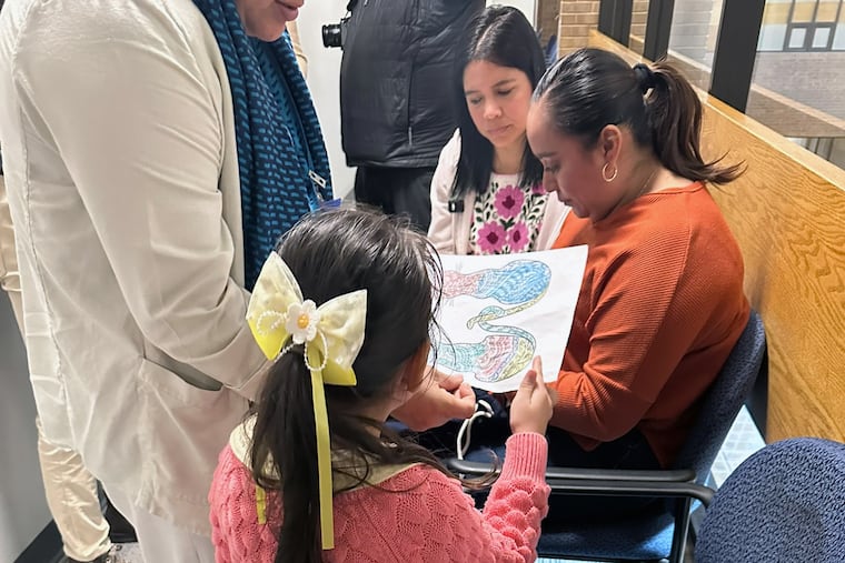 Sigrid Gonzalez, second from right, part of an immigrant court accompaniment program, speaks with Noemi, an immigrant from El Salvador, inside the Richard C. White Federal Building in El Paso, Texas, in November.