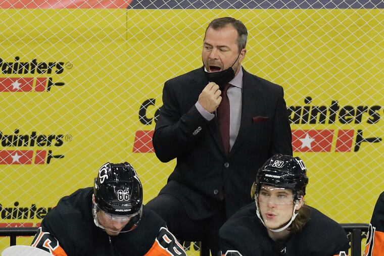 Flyers coach Alain Vigneault with Joel Farabee (left) and Nolan Patrick during a game against the Pittsburgh Penguins on May 3.