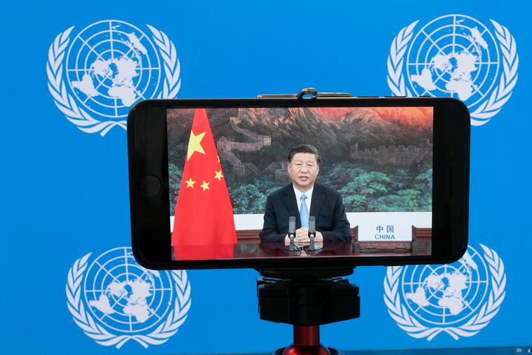 Chinese President Xi Jinping is seen on a video screen remotely addressing the 75th session of the United Nations General Assembly on Tuesday at U.N. headquarters.