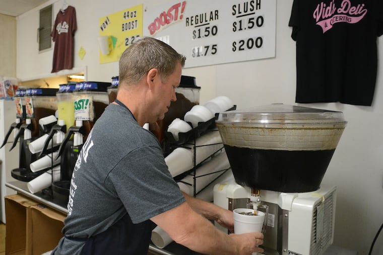 Mario Scott, owner of Vids deli, pours a Boost beverage in Delran, New Jersey.
