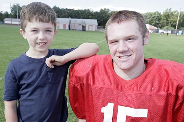 Delsea quarterback Quinn Collins greets 7-year-old Delsea fan Jimmy
Reardon. (Elizabeth Robertson/Staff Photographer)
