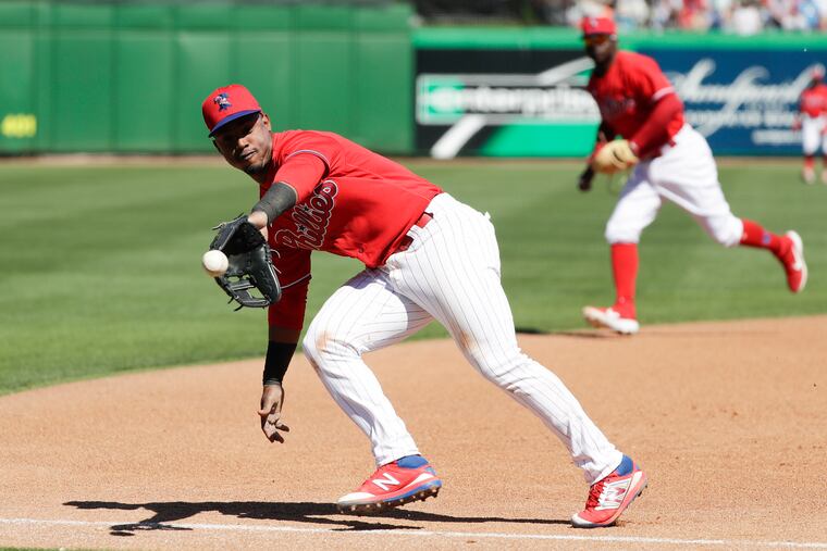 Phillies third baseman Jean Segura makes a backhanded grab of a foul ball in a March 7 spring-training game in Clearwater, Fla.