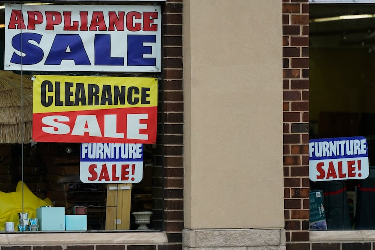 Sale signs are displayed at an appliance store in Arlington Heights, Ill., last week.