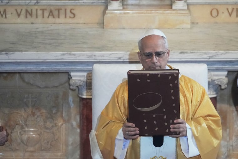 Pope Leo XIV holds the Gospel Book as he celebrates a Mass in the Saint Augustine Basilica in Annaba, Algeria, Tuesday, April 14, 2026, on the second day of an 11-day apostolic journey to Africa.
