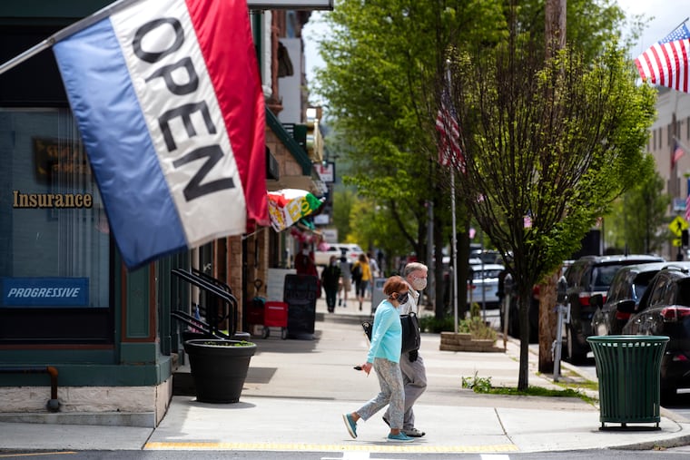 People wear masks along Main Street in Honesdale, Pa., on Friday, May 22, 2020. Many Wayne County businesses opened on Friday for the first time since March as the county moved to the yellow phase of reopening after the COVID-19 shutdown of nonessential businesses. Businesses should not have to contend with frivolous COVID-related lawsuits during their recovery, writes Curt Schroder of the Pennsylvania Coalition for Civil Justice Reform.