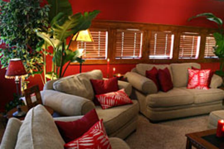 Fearless and fiery: Ramos designed this loft in warm red hues and tropical accents as a cozy island escape from the rest from the home.