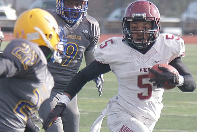 St. Joseph's Prep running back James Bell tries to turn the corner against Ben Franklin cornerback Romello Edwards. (Lou Rabito/Staff)