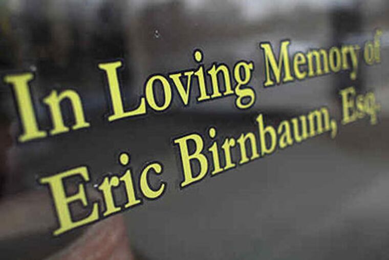 A tribute to slain attorney Eric Birnbaum (right) on the doorway to the office (above) where he worked. There's no known motive for the killing.