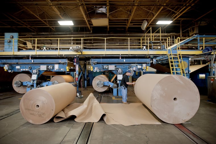 An International Paper Co. employee works on the floor of the company's factory in Mount Carmel, Pa.