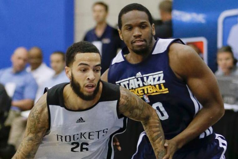 The Rockets' Tyler Honeycutt (left) drives to the basket past Utah Jazz's Dionte Christmas (right) during an NBA summer league basketball game, Tuesday, July 9, 2013, in Orlando, Fla. (John Raoux/AP)
