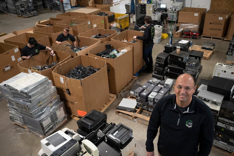 Serdar Bankaci, president of CyberCrunch, an electronics recycling and data destruction service, poses with refuse to be destroyed at the company’s facility in Greensburg, Pa. on Jan. 13, 2022.