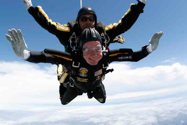 Former President George H. W. Bush rides with Sgt. First Class Mike Elliott of the Army Golden Knights parachute team as they zoom downward over his hometown of Kennebunkport, Maine, to celebrate his 85th birthday. "It was a great day in the air," he quipped later.
