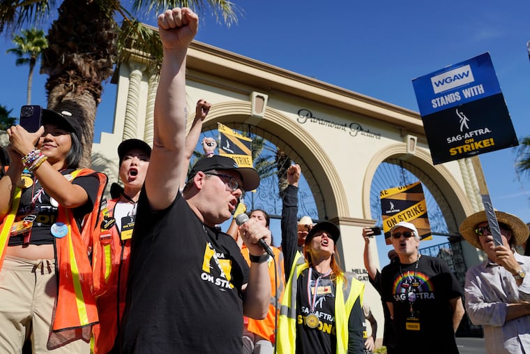 SAG-AFTRA chief negotiator Duncan Crabtree-Ireland, left, rallies striking actors in outside Paramount Pictures studio Nov. 3 in Los Angeles.