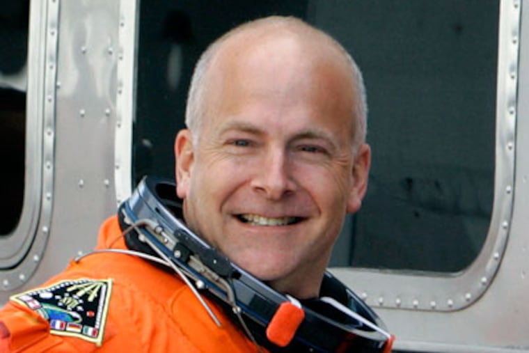 FILE - In this Feb. 7, 2008 file photo, STS-122 Pilot Alan Poindexter waves to members of the media as he prepares to board the astronaut van for a trip to Launch pad 39-A and a planned liftoff on the space shuttle Atlantis Thursday Feb. 7, 2008 at the Kennedy Space Center in Cape Canaveral, Fla. Capt. Poindexter died Sunday July 1, 2012, following a personal watercraft accident in Little Sabine Bay at Pensacola Beach, Fla. He was 51. (AP Photo/Chris O'Meara, File)