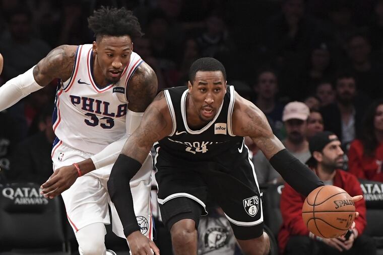 Nets forward Rondae Hollis-Jefferson (24) handles the ball ahead of 76ers forward Robert Covington (33) during the second half.