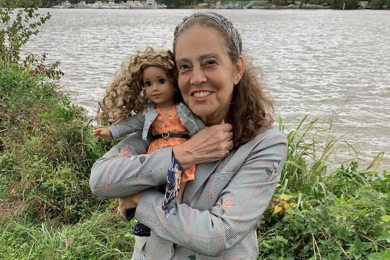 Sharon Dennis Wyeth, 73, and Evette, the American Girl doll whose story she wrote, posing in front of the Anacostia River, which is part of the doll’s backstory and Wyeth’s childhood in D.C.