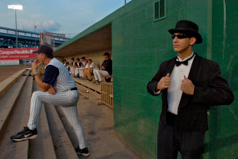 The enigmatic Mr. Trash's official bio says he's an usher. But what usher dances across home plate in a tux with a Waste Management logo across his back?