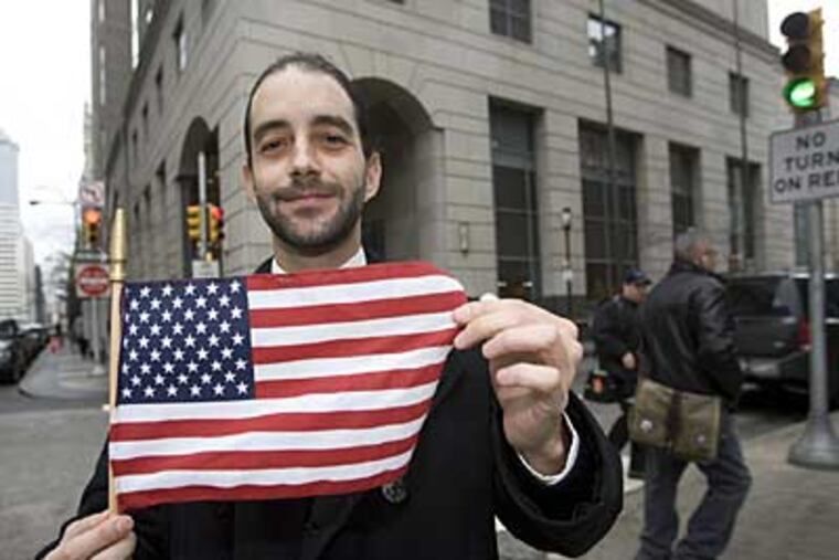 Ralph Silvestro, a legal clerk who works at the front counter at the Criminal Justice Center, is shown here with a American flag. (Jessica Griffin /
Staff Photographer)