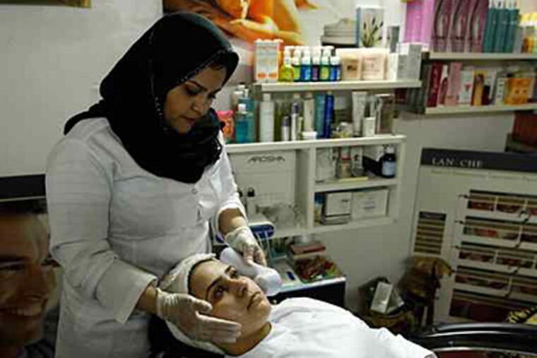 In a culture where women reveal little in public, Saudi women see nothing unusual about having plastic surgery and then covering it up. At left, a woman undergoes skin lightening at a clinic in Riyadh, the capital.