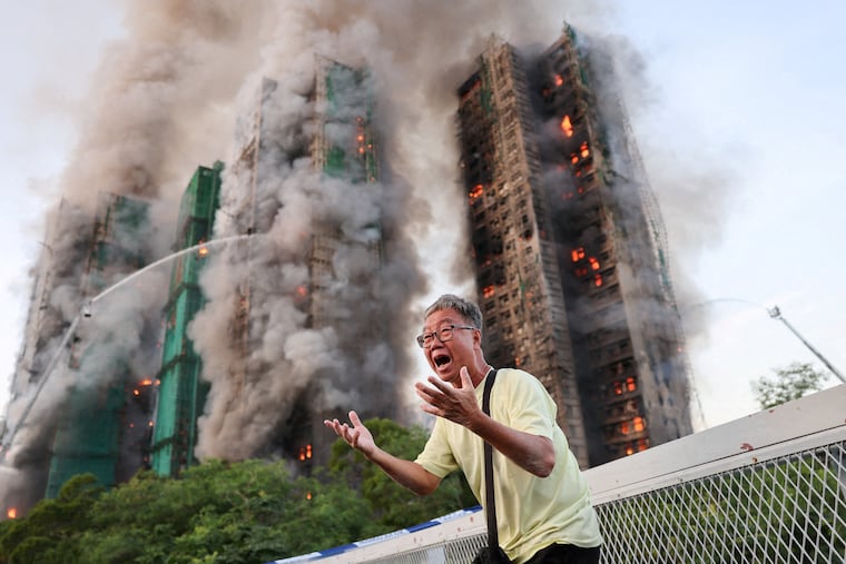 A man who claimed his wife was trapped inside Wang Fuk Court stands outside of the burning building in Hong Kong, China, on Wednesday, Nov. 26.