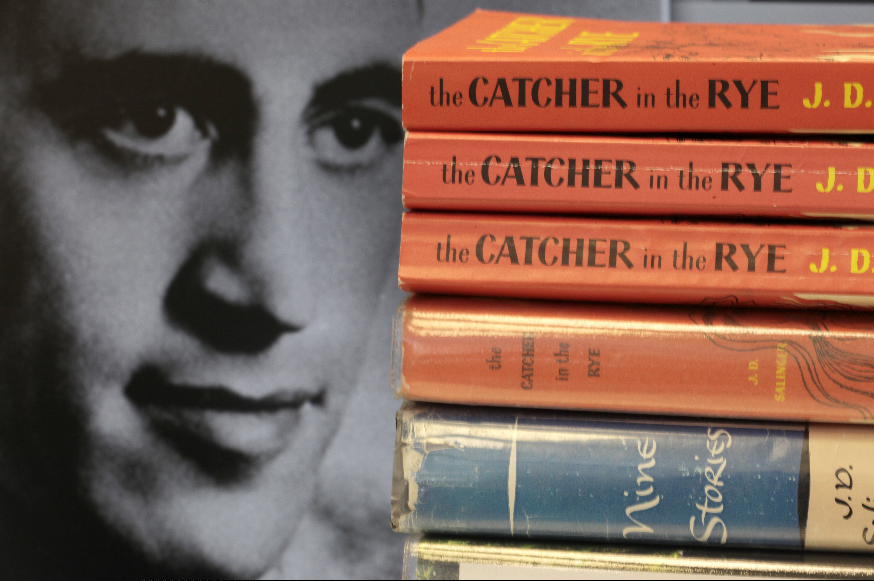 FILE - This Thursday, Jan. 28, 2010, file photo shows copies of J.D. Salinger's classic novel "The Catcher in the Rye" as well as his volume of short stories called "Nine Stories" at the Orange Public Library in Orange Village, Ohio. In comments that appeared Friday, Feb. 1, 2019, in the Guardian, Matt Salinger, son of the famous author, confirmed long-standing reports that his father had continued to write long after he stopped publishing books and that he and Salinger’s widow are “going as fast as we freaking can” to prepare the material for release.